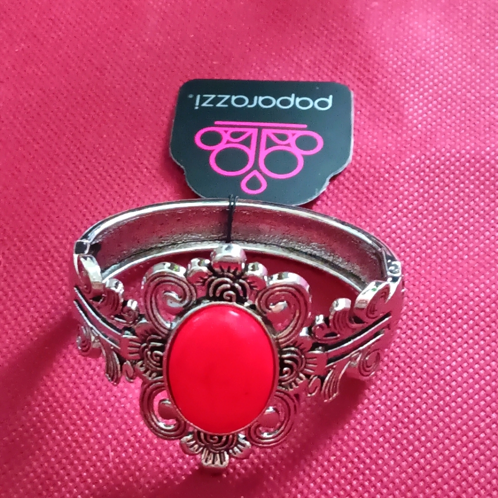 Spring clip ornate braclet with pink center piece.